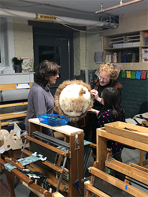 Jeane Bruffee and Susan Gruen working on a weaving project together